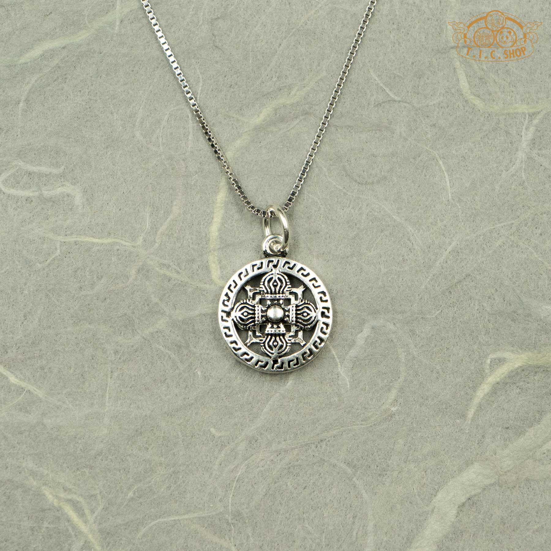 Close-up of the 925 silver Double Vajra pendant showing the intricate ritual carvings and polished finish.