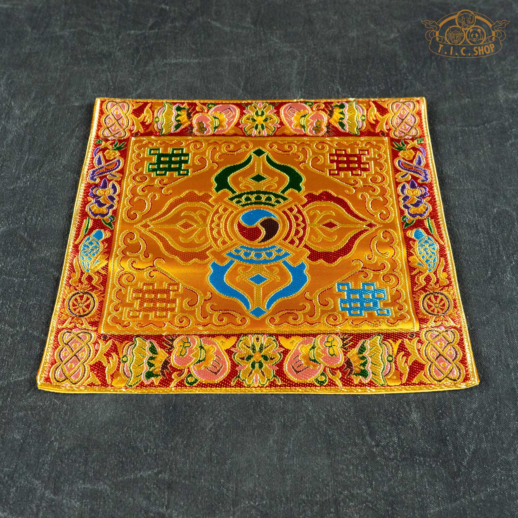 Top view of the 22x22 cm Double Vajra table mat(yellow) highlighting the symmetrical pattern and rich ornamental borders.
