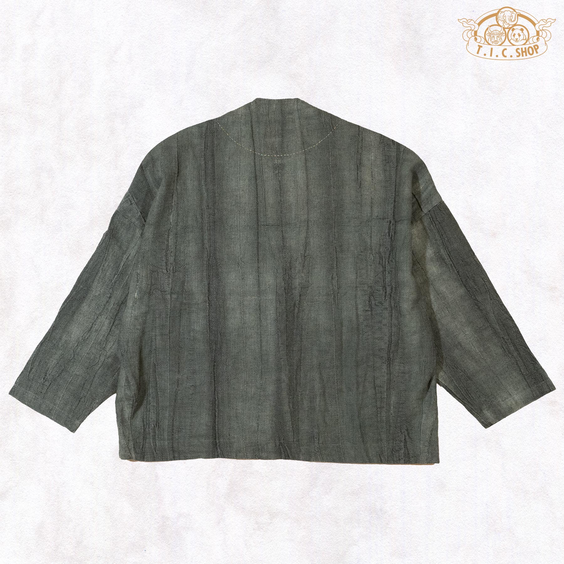 The back of the green linen top showing its clean, minimalist silhouette and the rich depth of the hand-dyed color.