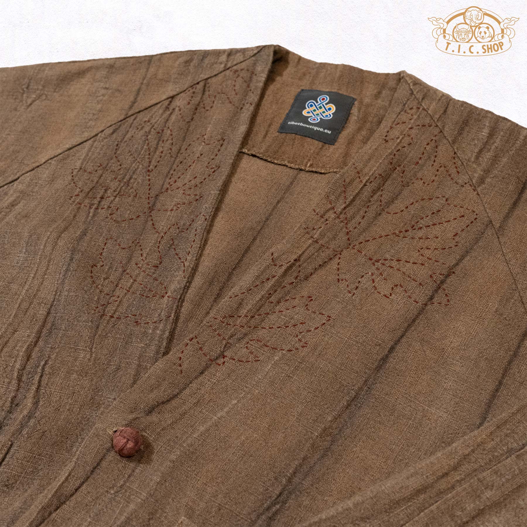 Close-up of the neckline featuring delicate hand-embroidered floral patterns and intricate needlework.