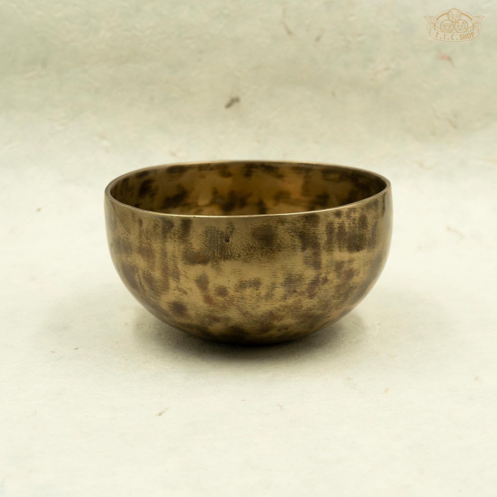 Side view of Tibetan antique singing bowl made of brass, handcrafted in Nepal, for meditation and spiritual practice.