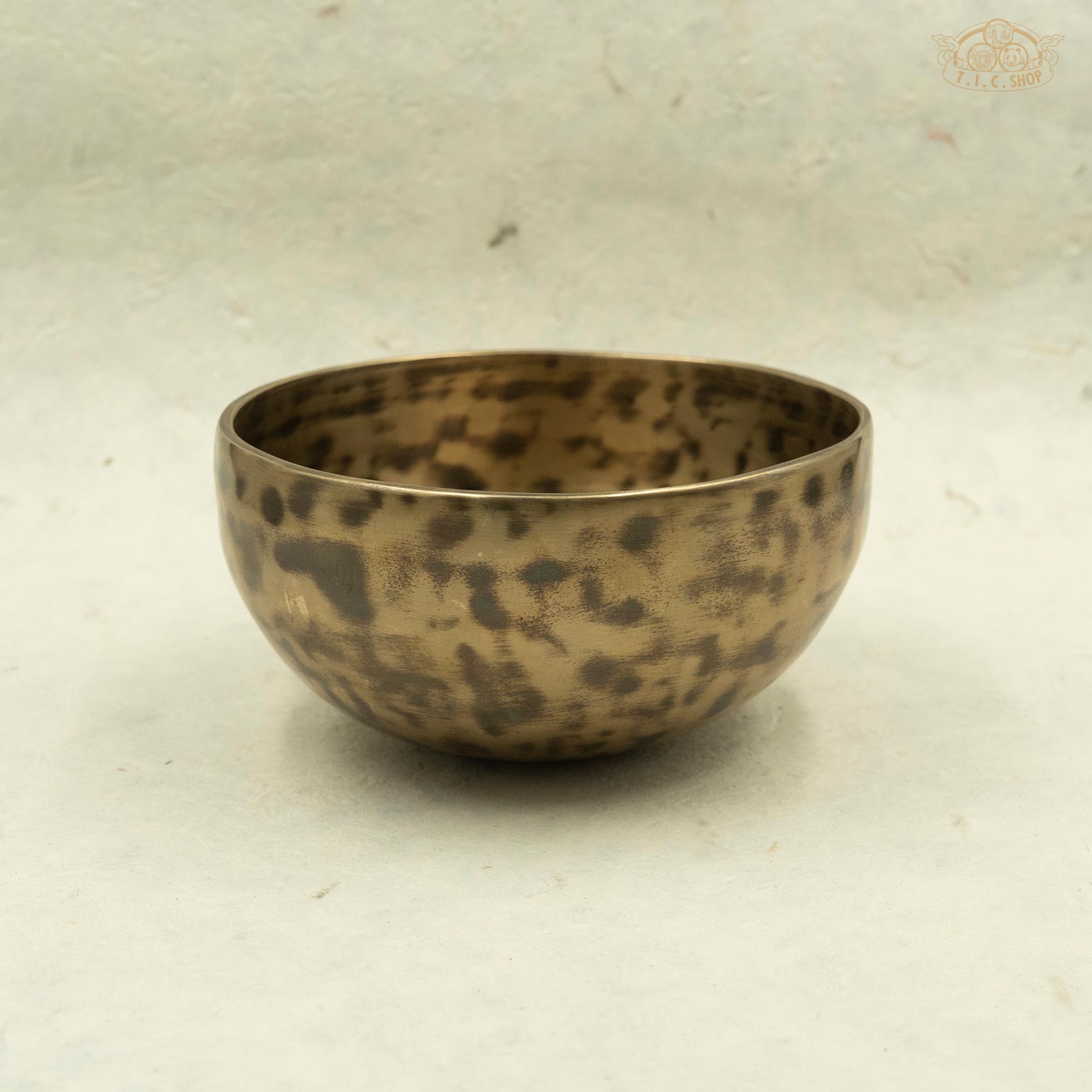 Side of a Tibetan handcrafted brass singing bowl made by Nepalese artisans, Showcasing the antique color.