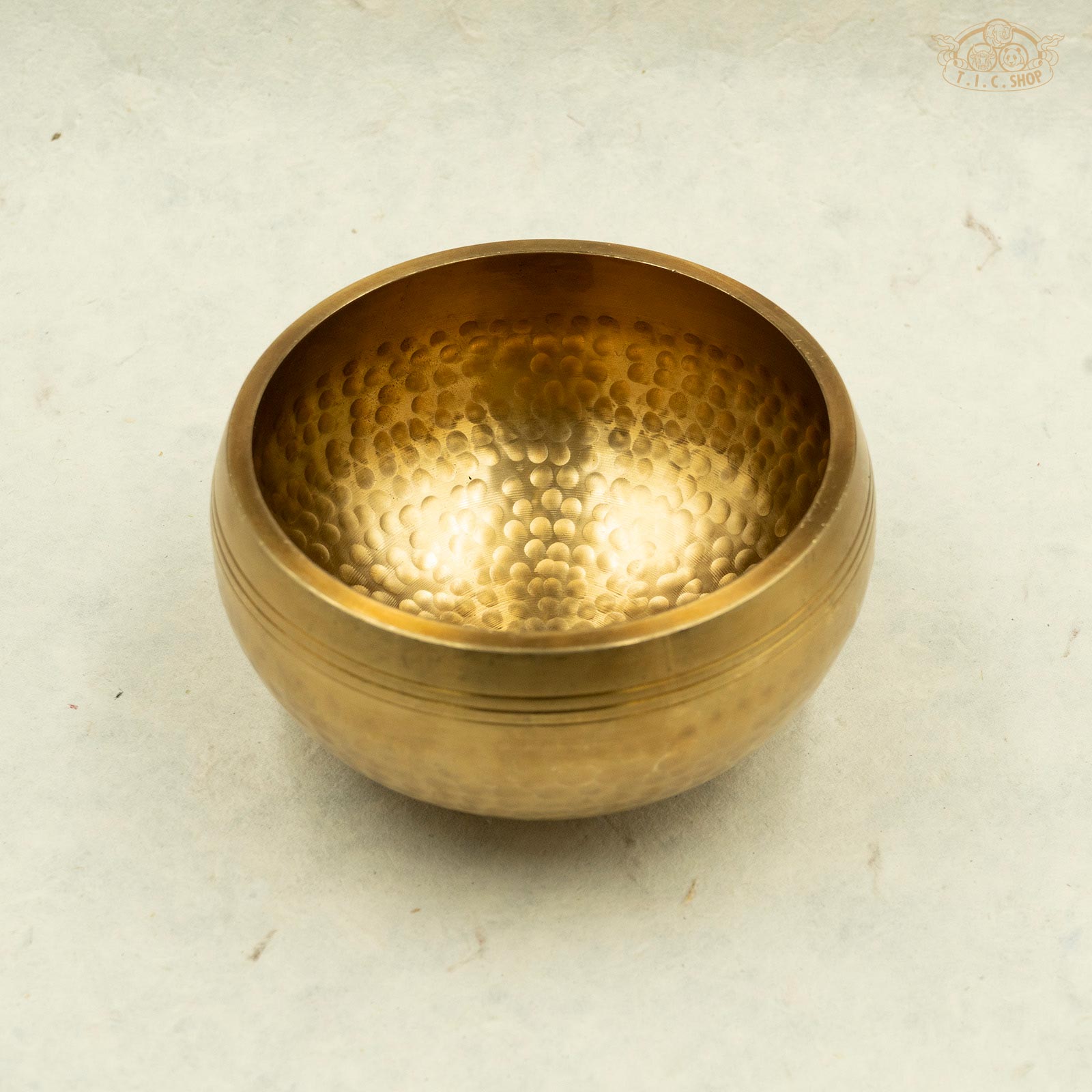 Front view of Tibetan brass singing bowl with a hammer texture pattern, for meditation and spiritual practice