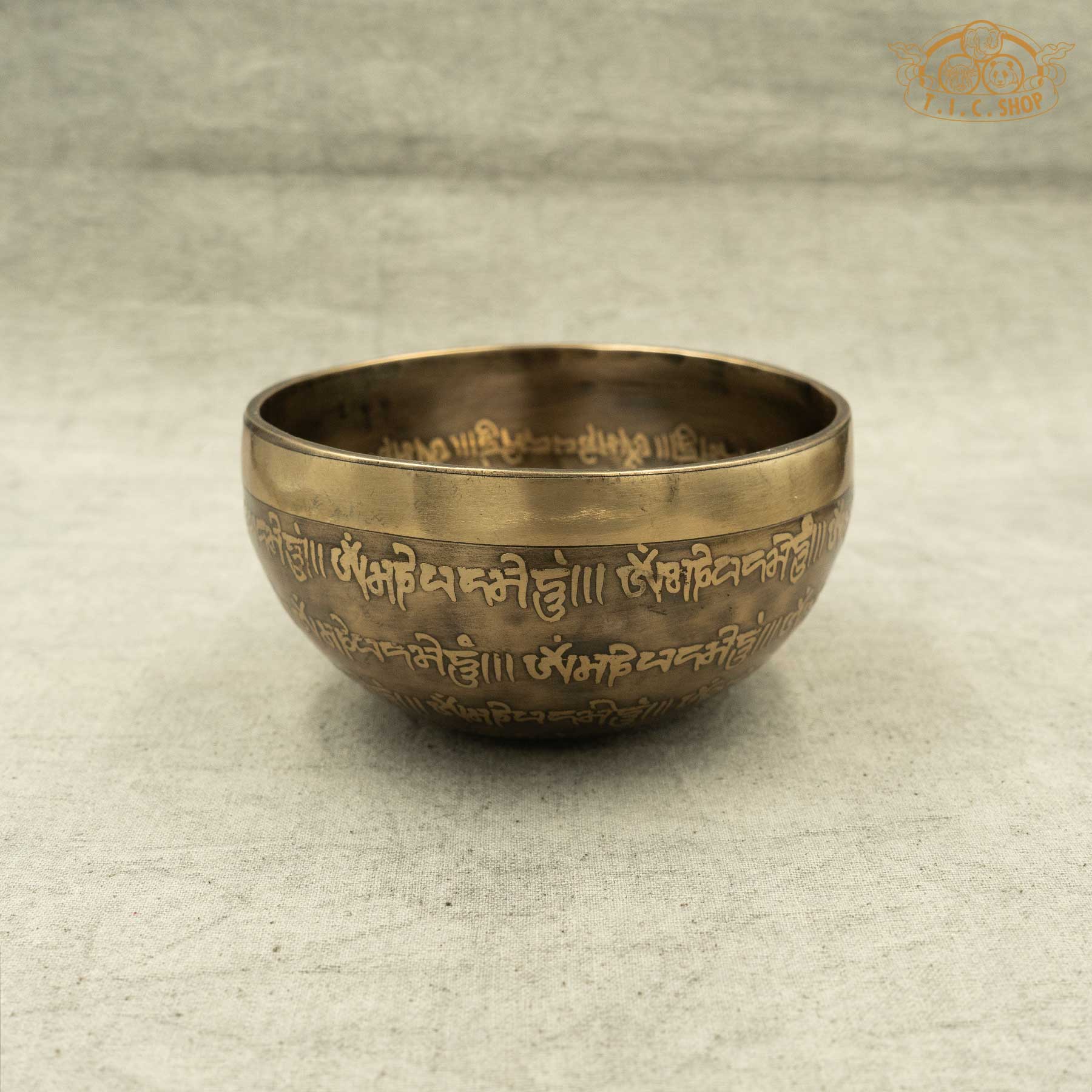 Side view of Tibetan Singing Bowl with lotus symbol and OM MANI PADME HUM Mantras, handmade in Nepal for meditation and spirtual practice