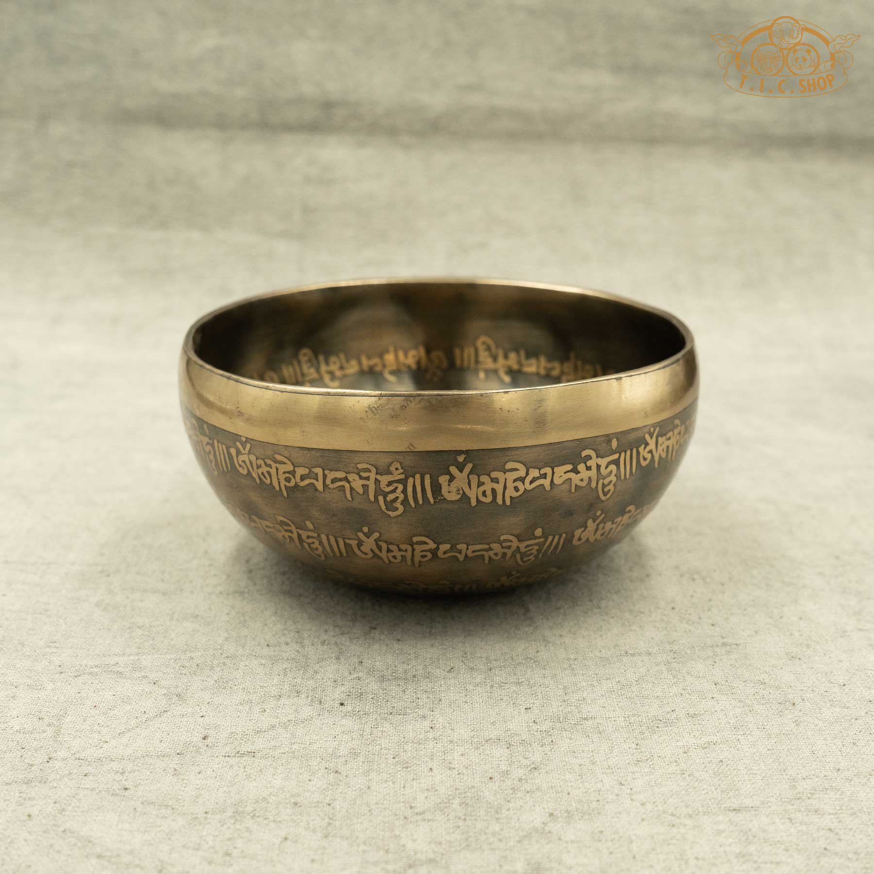 Side view of Tibetan Singing Bowl with OM Symbol and OM MANI PADME HUM Mantras, handmade in Nepal for meditation and spiritual