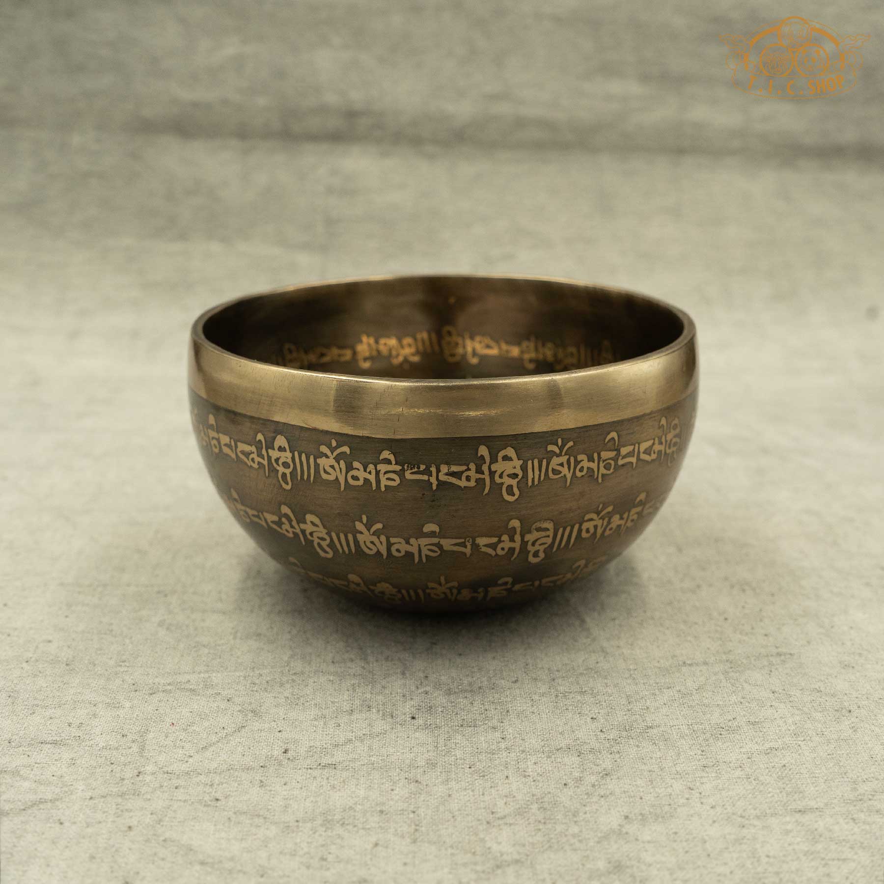 Side view of Brass Tibetan singing bowl with engraved OM symbols and Lotus pattern,OM MANI PADME HUM Mantras, handmade by Nepalese artisans for meditation and spiritual practice