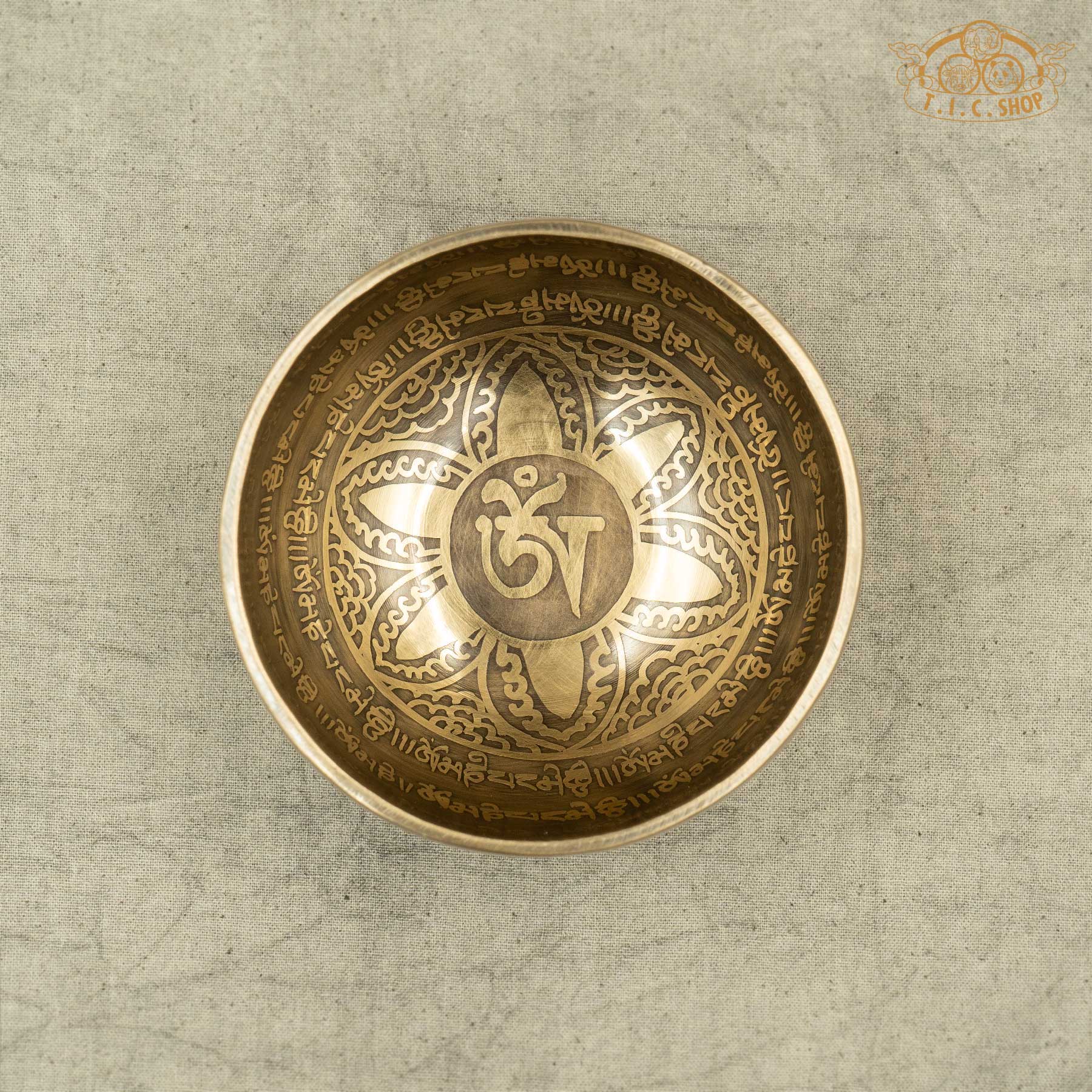 Top view of Brass Tibetan singing bowl with engraved OM symbols and Lotus pattern,OM MANI PADME HUM Mantras. Handmade by Nepalese artisans for meditation and spiritual practice