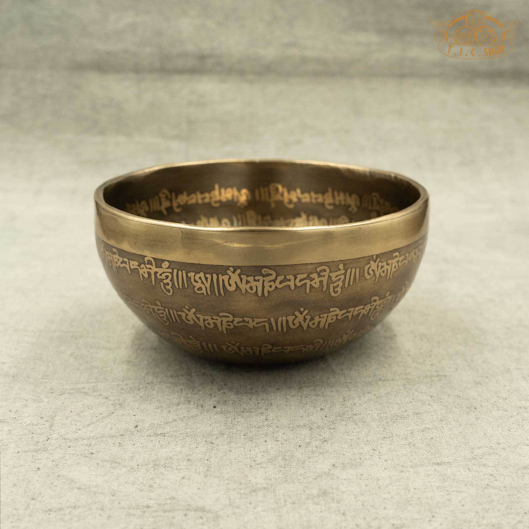 Side view of Tibetan Singing Bowl with Lotus Symbol and OM symble, handmade in Nepal for meditation and spiritual practice