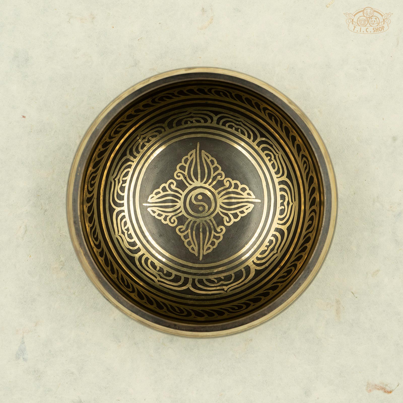 Top view of Vajra Singing Bowl showing detailed central vajra and Yin-Yang design surrounded by lotus petal pattern and Tibetan mantra engraving.