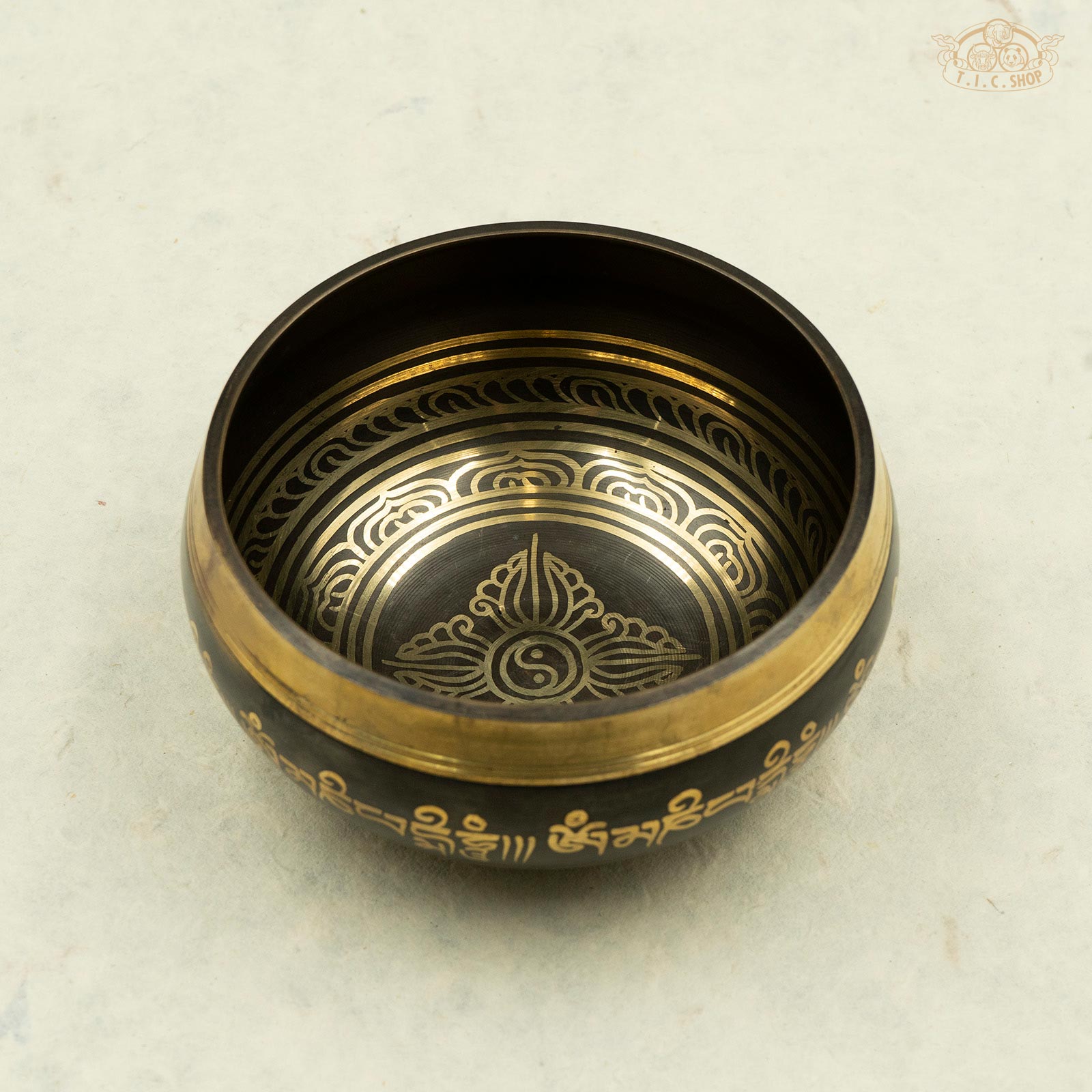 Vajra Singing Bowl 13cm front view showing engraved double vajra and Yin-Yang symbol centered with lotus border and Om Mani Padme Hum mantra around the rim.