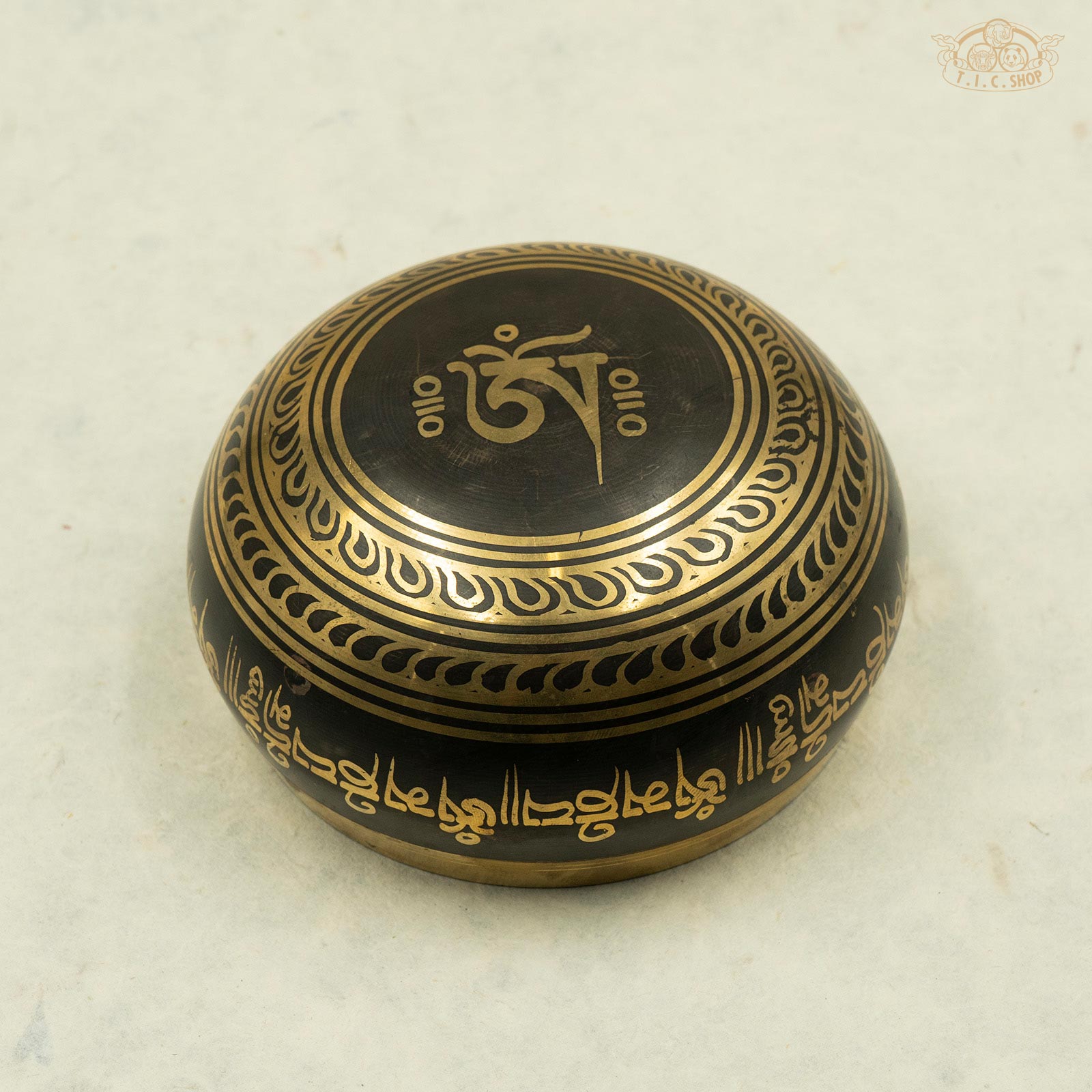 Base view displaying OM Symbol carving with detailed traditional Nepalese brass craftsmanship