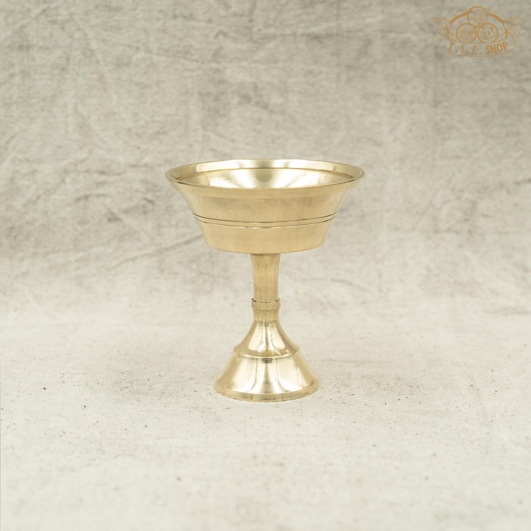 Front view of small brass butter lamp with simple traditional design and smooth finish.