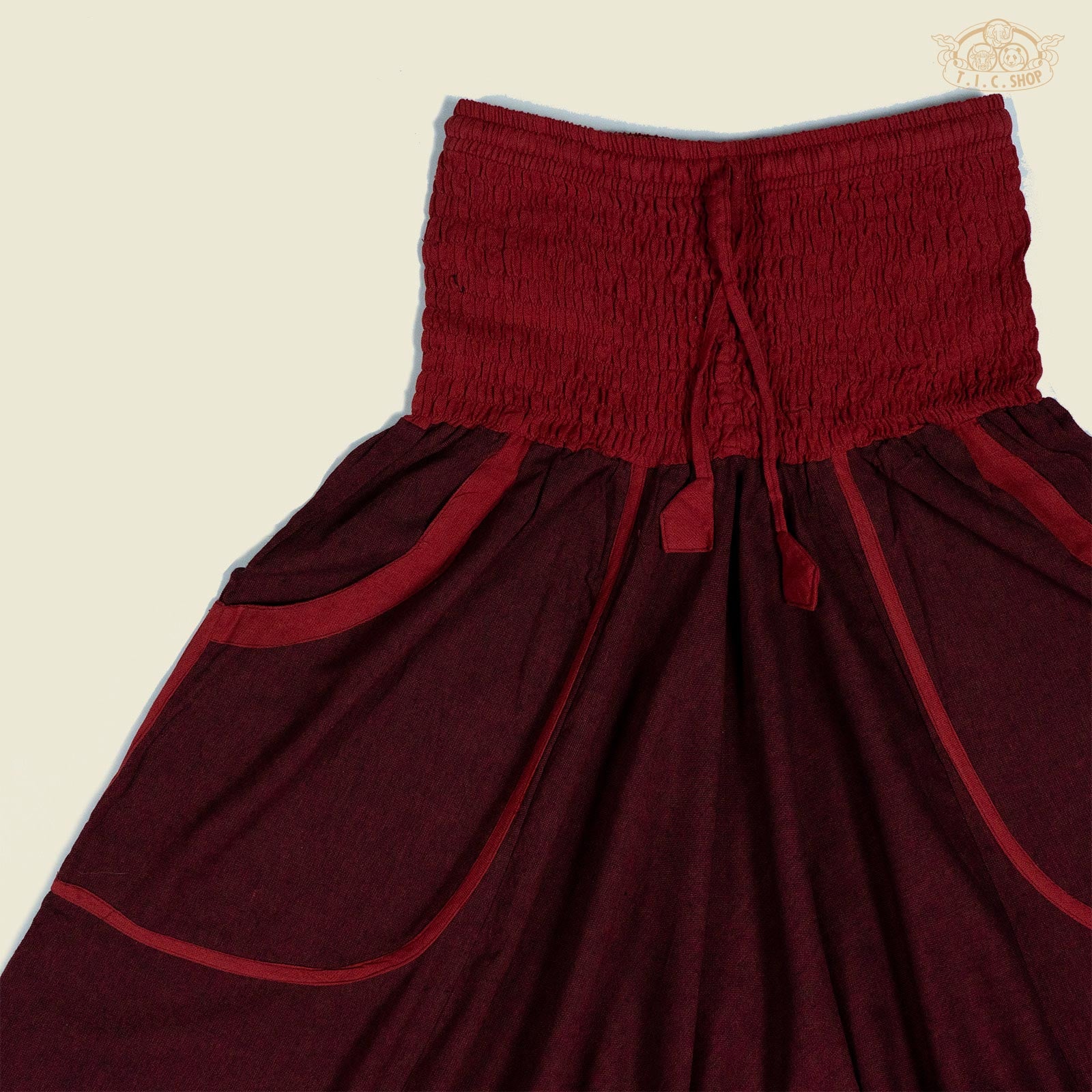 Close-up of the drawstring waist and cotton fabric texture of the trousers.