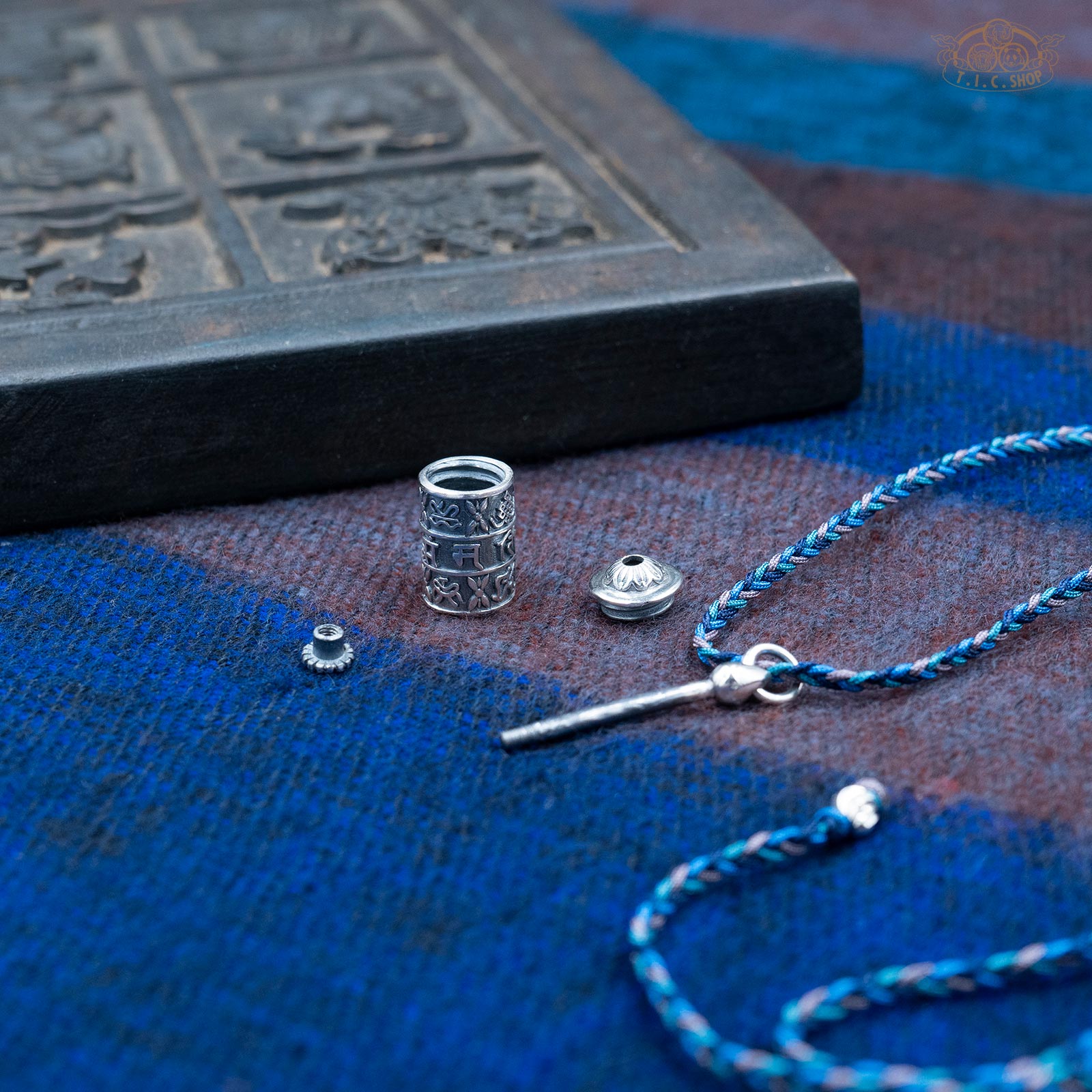 Open silver Gau amulet box pendant showing screw-top lid and interior