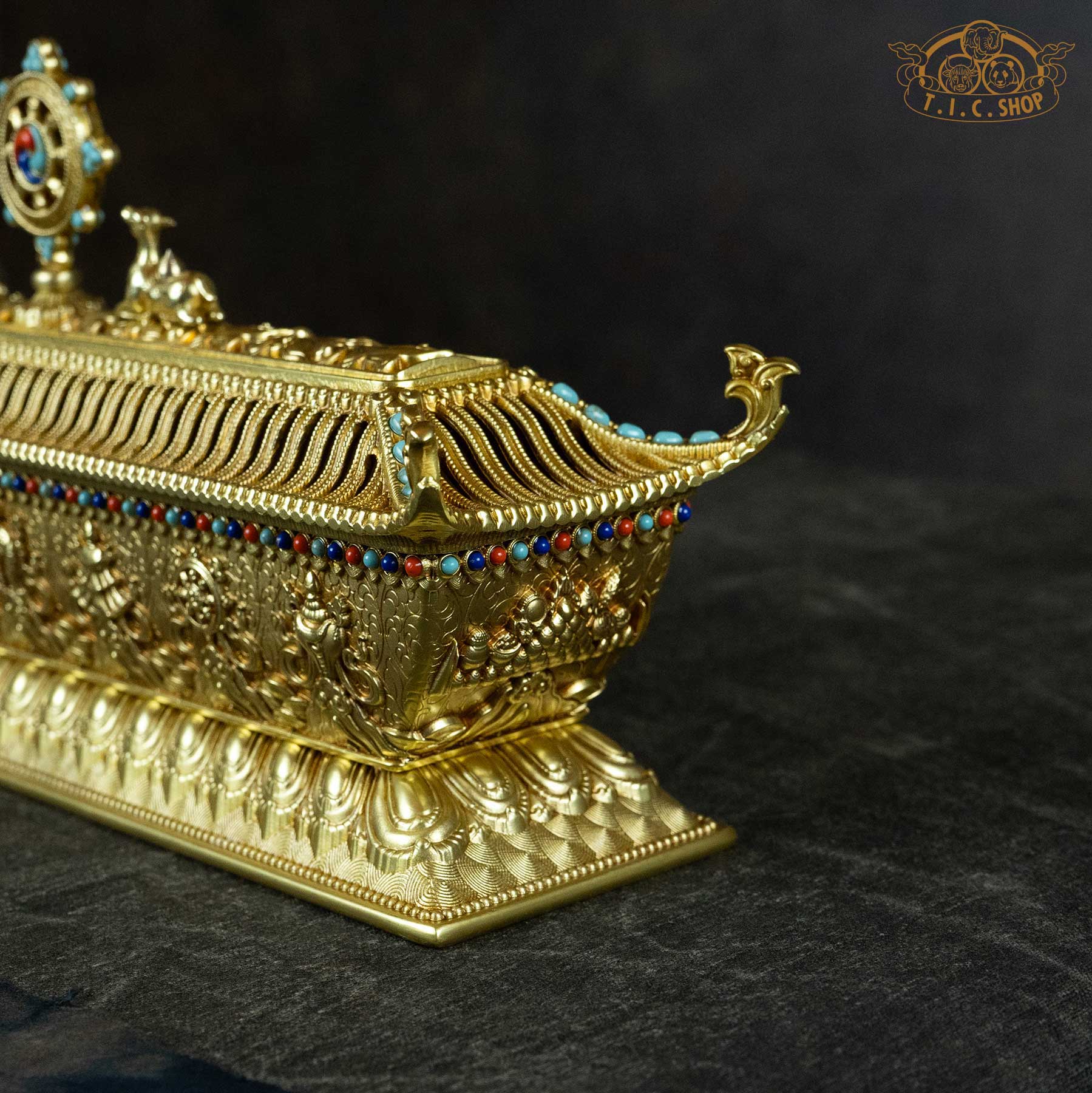 Close-up detail of lotus base and mythical beast (taotie) decorations on brass incense burner.