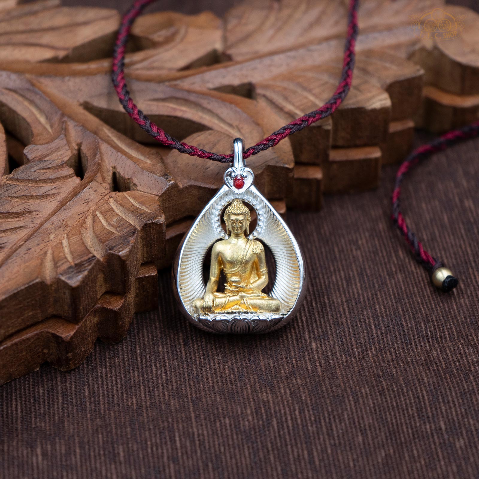 Amulet pendant featuring a brass Shakyamuni Buddha figure seated on a lotus, front view with finely carved details