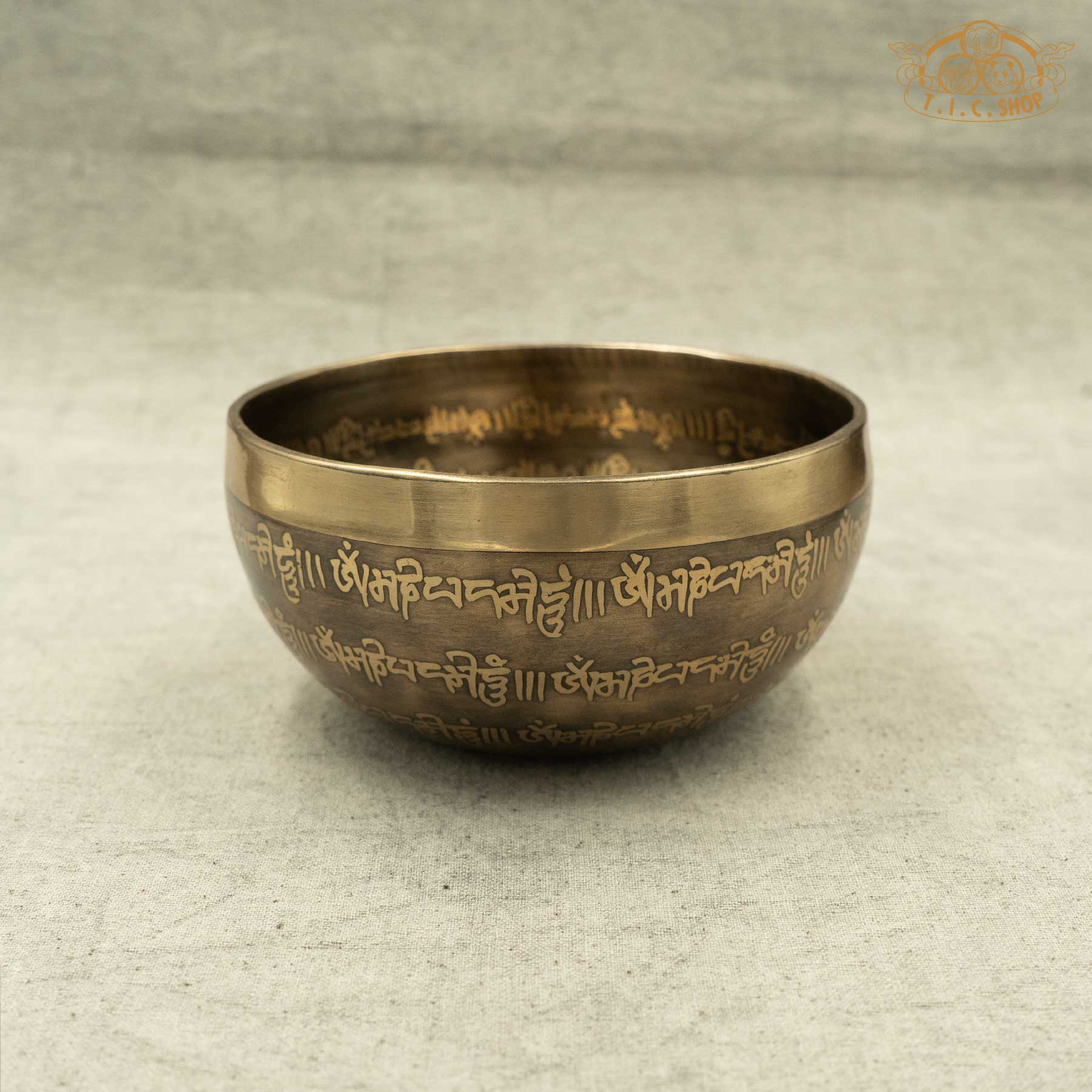 Side view of Handmade Tibetan singing bowl from Nepal with carved OM MANI PADME HUN mantra and Mandala pattern for meditation and healing