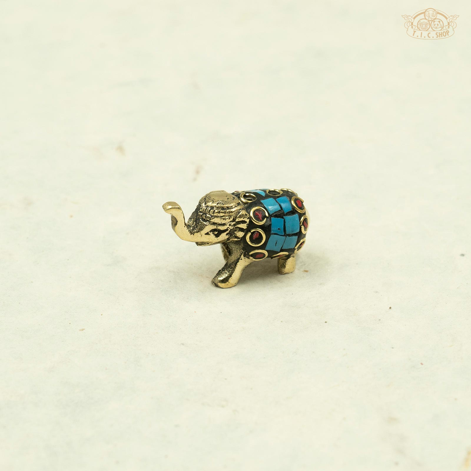 turquoise color_Side view of small brass elephant incense stand showing detailed artisan carving.