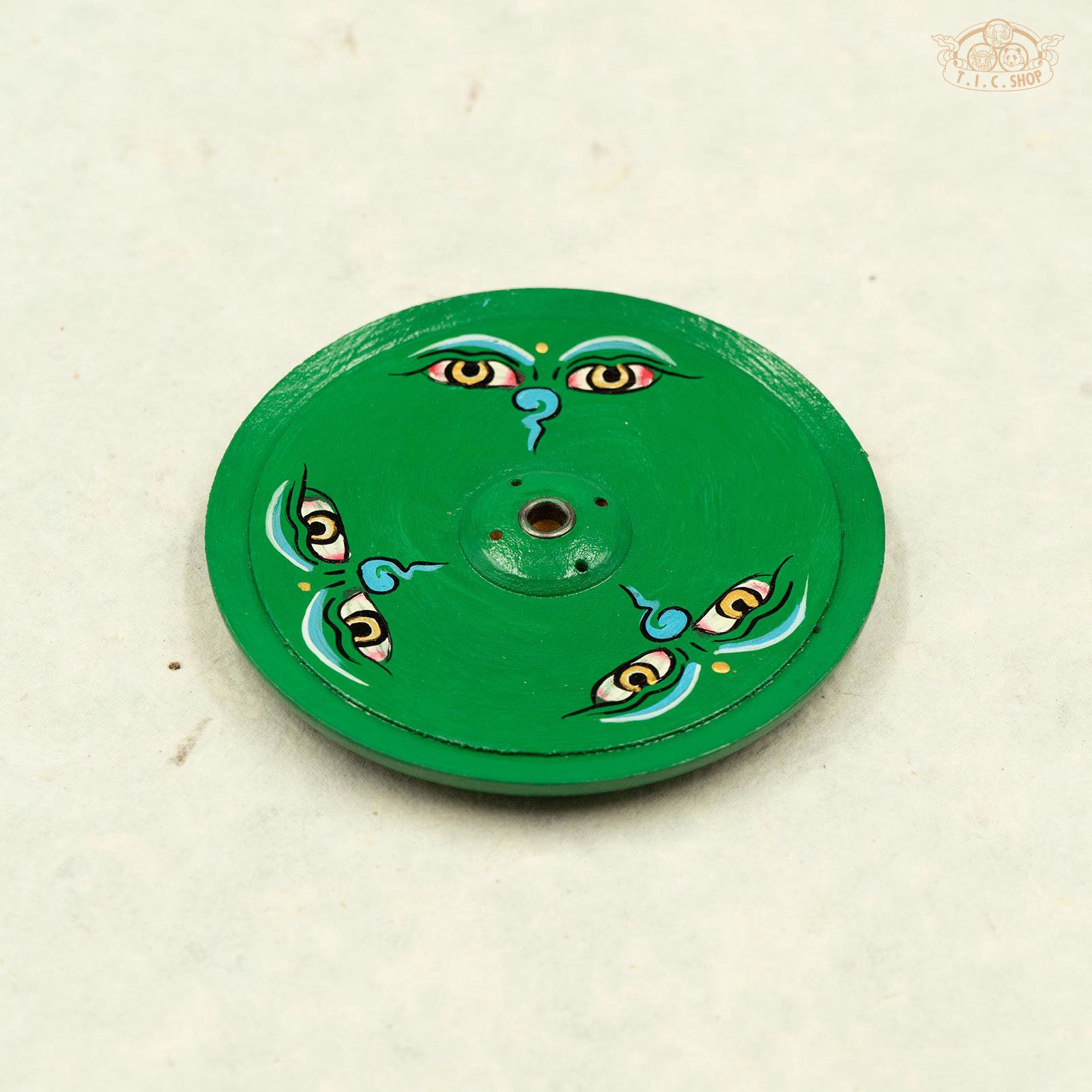 Tibetan wooden incense holder hand-painted with Buddha eyes symbols.