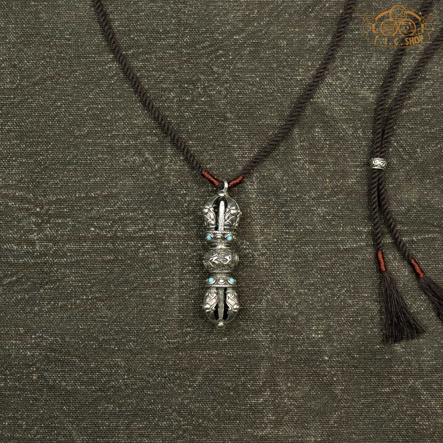 Vajra pendant with blue beads, showing double-ended symmetrical Vajra symbol