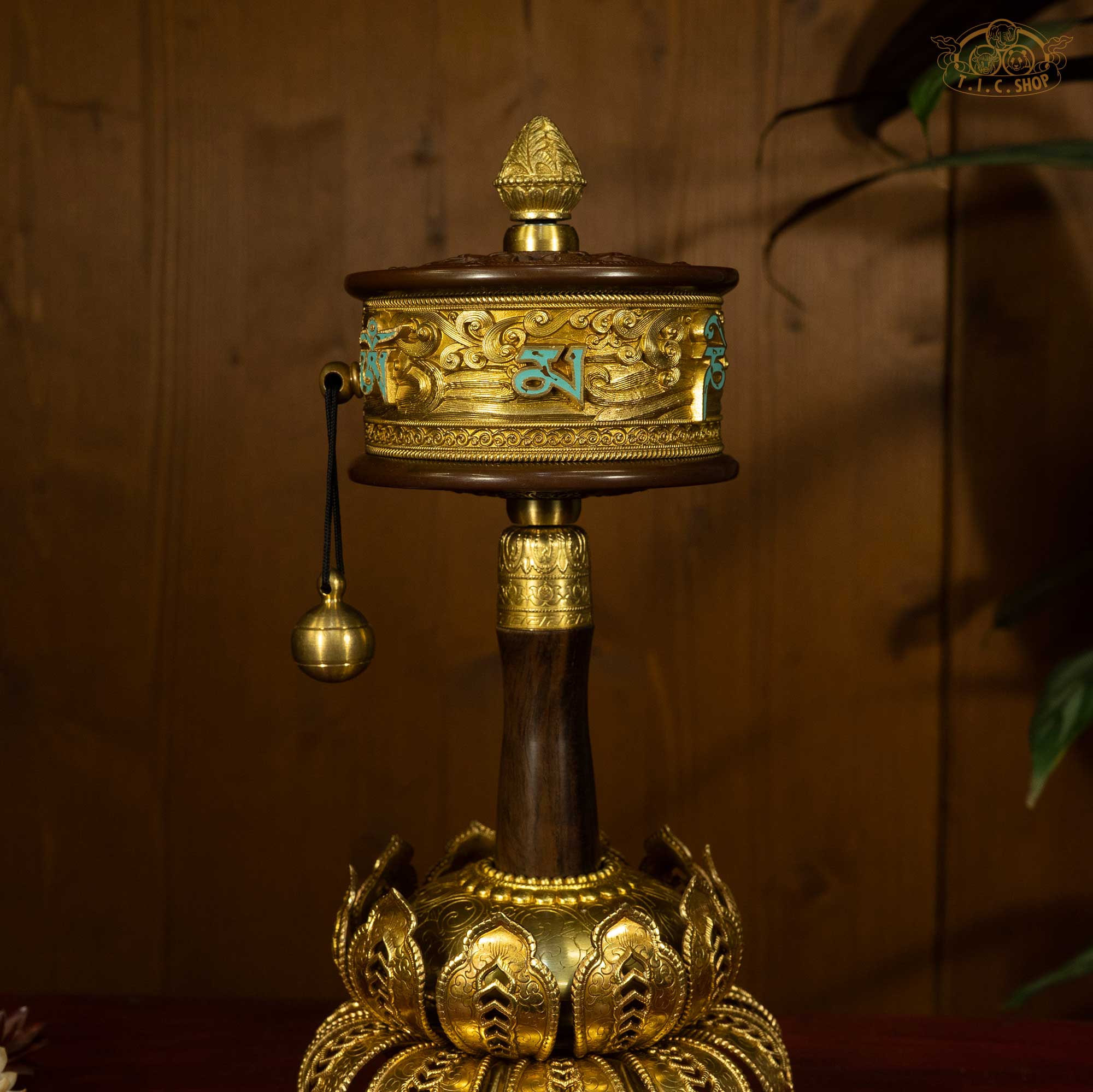 Close-up of Six Syllable Mantra Om Mani Padme Hum carved on golden prayer wheel