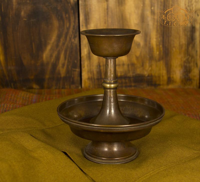Antique finish brass Serkym cup and plate set, front view.