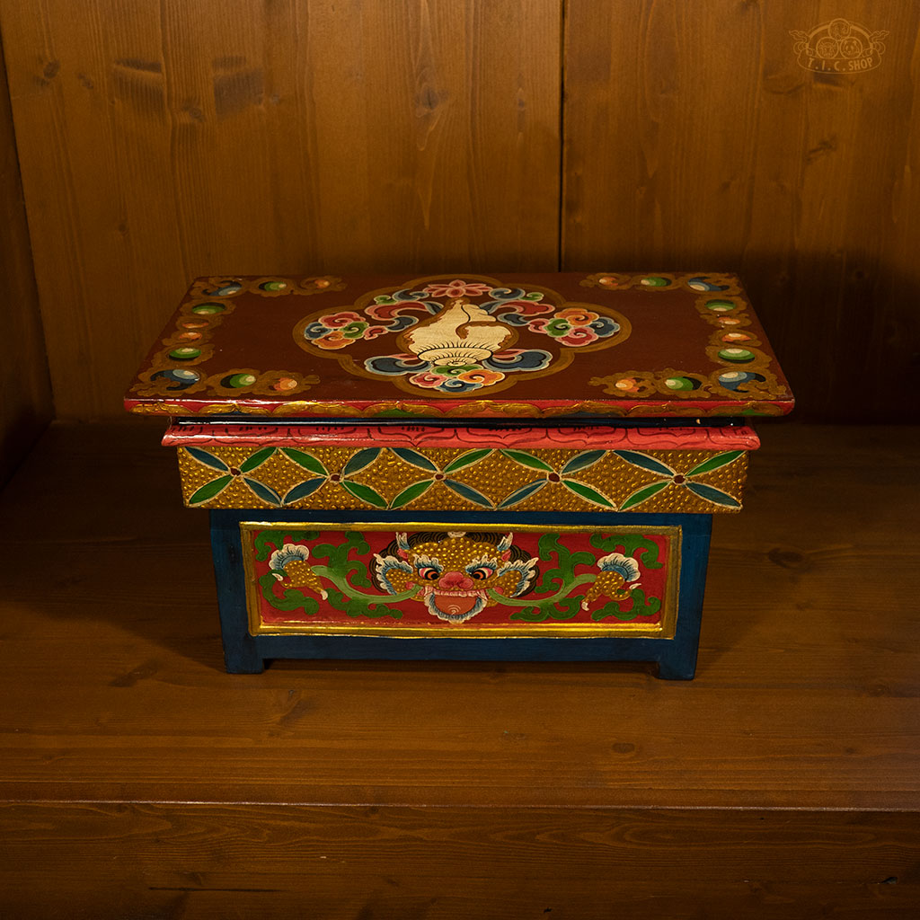 Hand-painted Tibetan folding meditation table arranged in a home altar setting for Buddhist practice