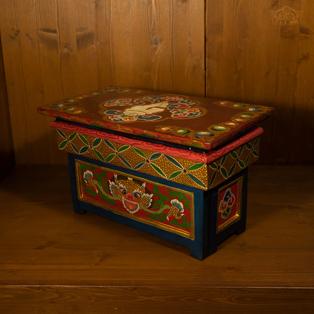 Side view of traditional Tibetan folding meditation table with colorful hand-painted patterns