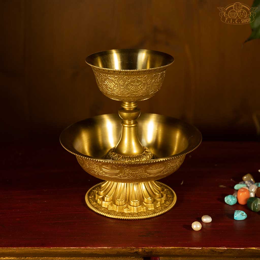 Top view of Tibetan brass Serkyem offering set showing traditional decorative details