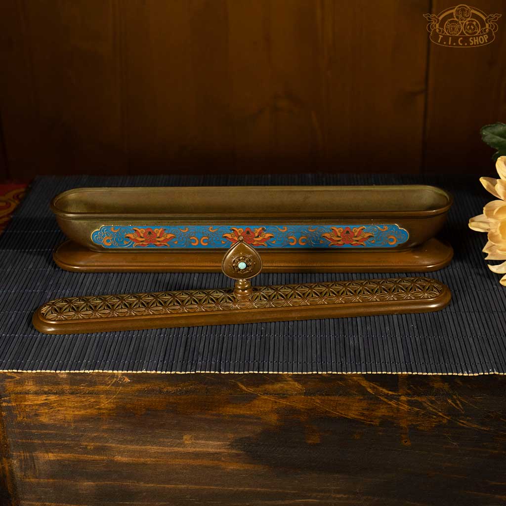 The blue enamel patterns and openwork lid on brass incense burner, showcasing traditional cloisonné technique.