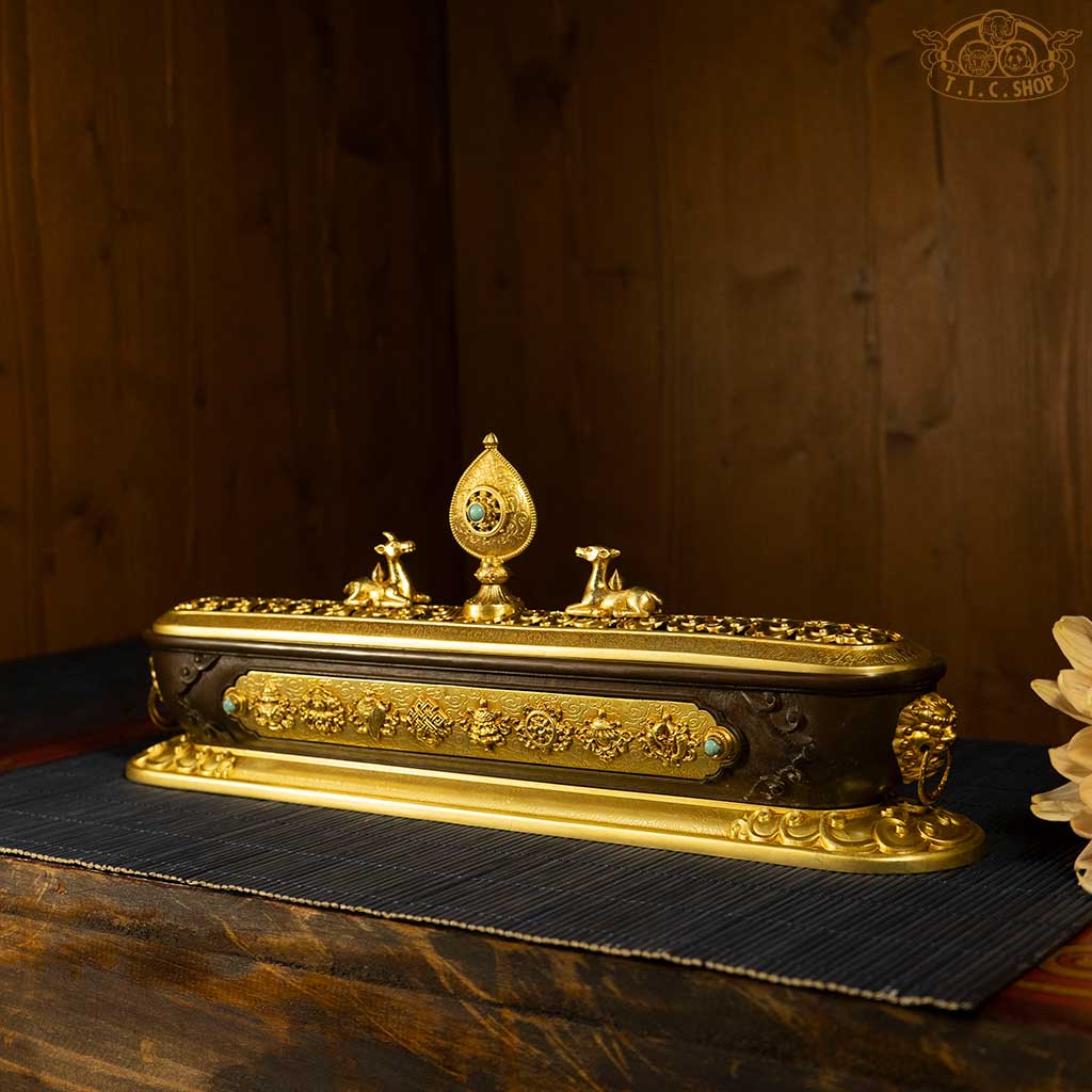 Side view of brass incense burner with bronze and gold finish, showing detailed craftsmanship and taotie motifs.