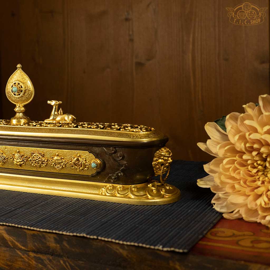Close-up detail of openwork lid and cloud patterns on the double deer dharma wheel incense burner.