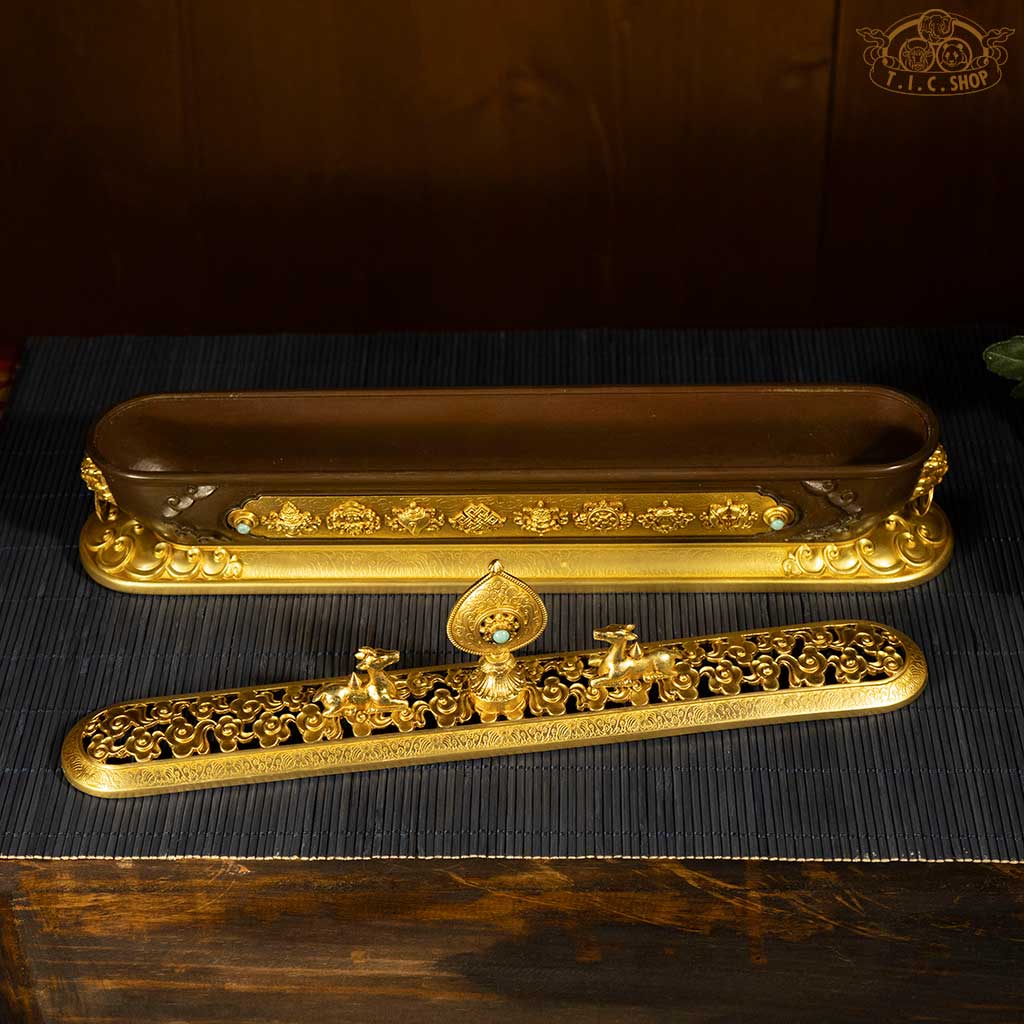 Top view of the open lid revealing interior space for incense and intricate decorative elements.