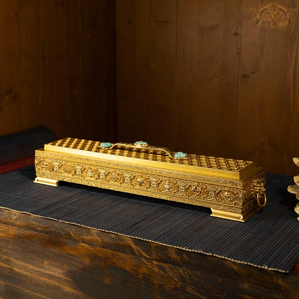 Side view of collector’s brass incense burner showing detailed taotie motifs and bright colors.