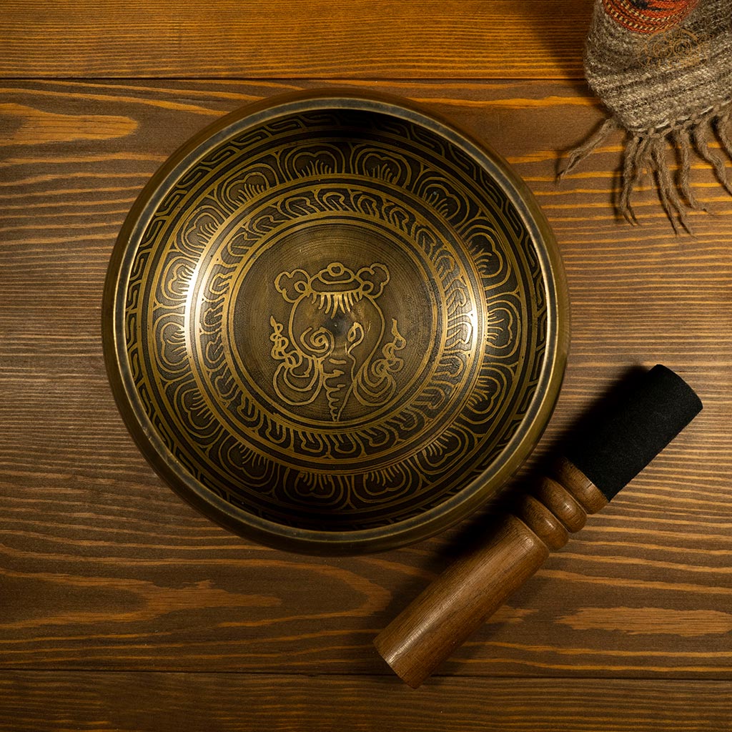 Top view of a brass Tibetan singing bowl, showing its beautiful pattern smooth inner surface