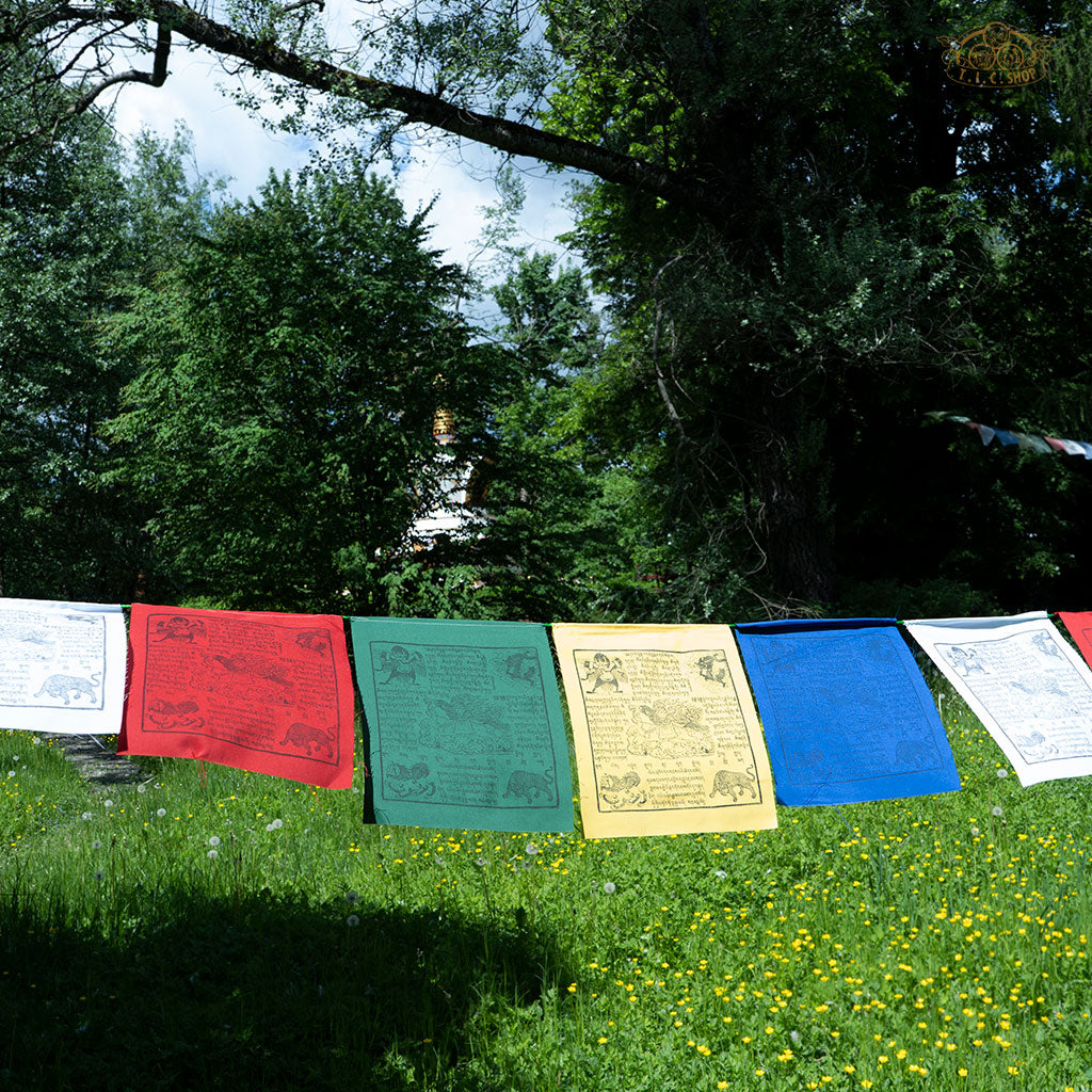 Hand-printed Tibetan Windhorse prayer flags hanging outdoors, made of cotton, promoting protection, luck, and peace