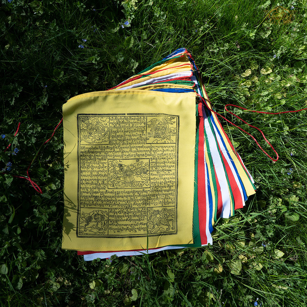 Close-up of colorful cotton Tibetan Windhorse prayer flag featuring traditional auspicious symbols for luck and protection