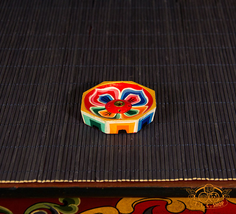 Side view of octagonal incense holder showing traditional Tibetan hand-painted details.