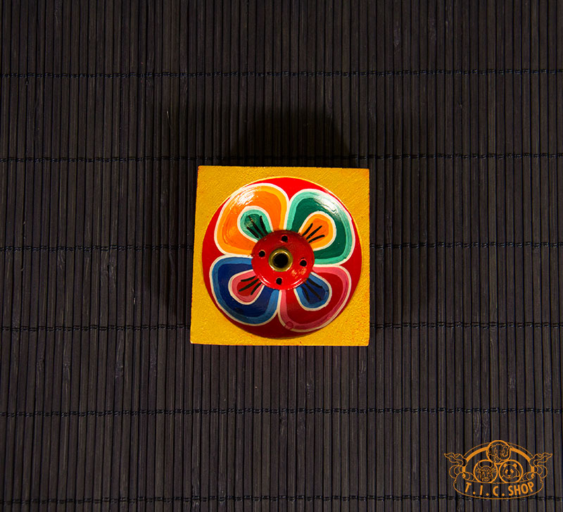 Top-down view of lotus-patterned wooden incense holder for Tibetan and Indian incense sticks.