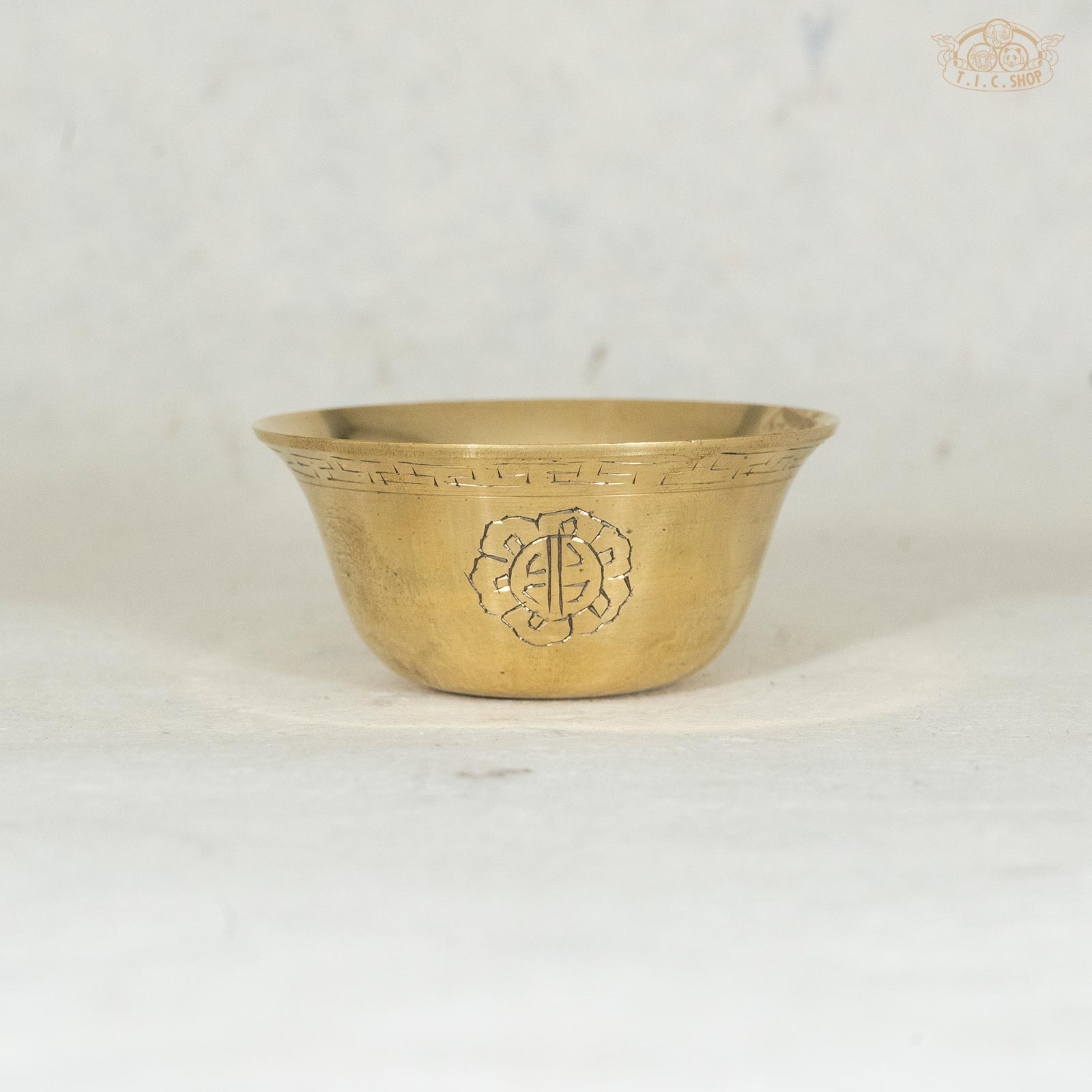 8.5cm Brass offering bowl with ornamental designs, displayed against a textured background