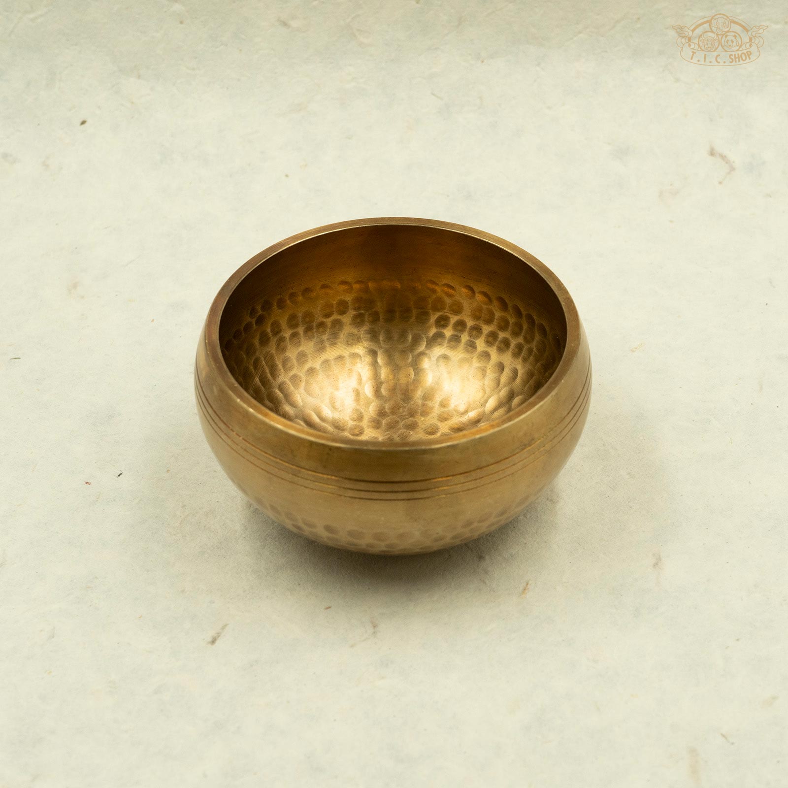 Front of Tibetan handcrafted brass singing bowl handmade by Nepal artisans,full of positive energy for meditation and spiritual practice.