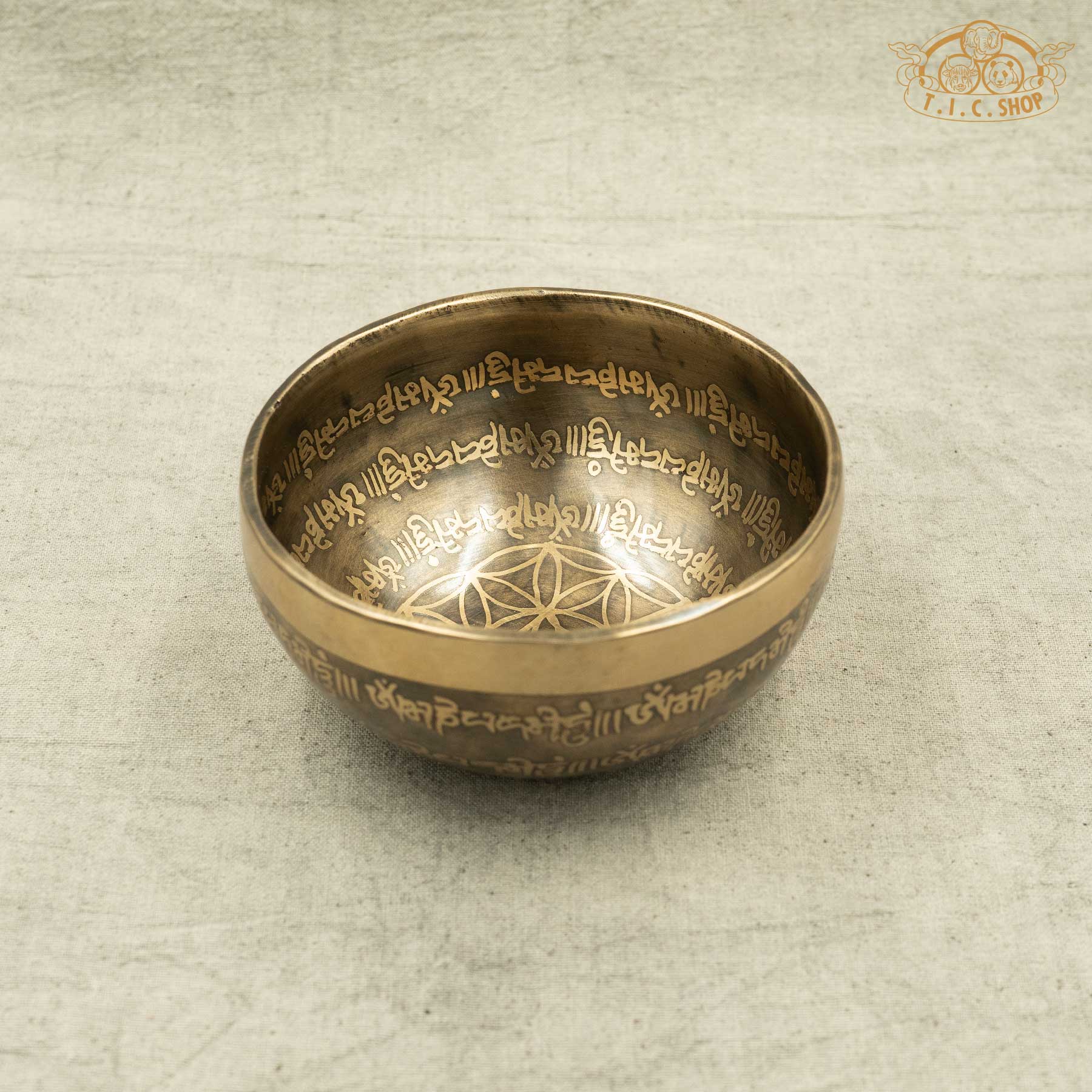 Front view of Bronze singing bowl with engraved text OM MANI PADME HUM Mantras for meditation 