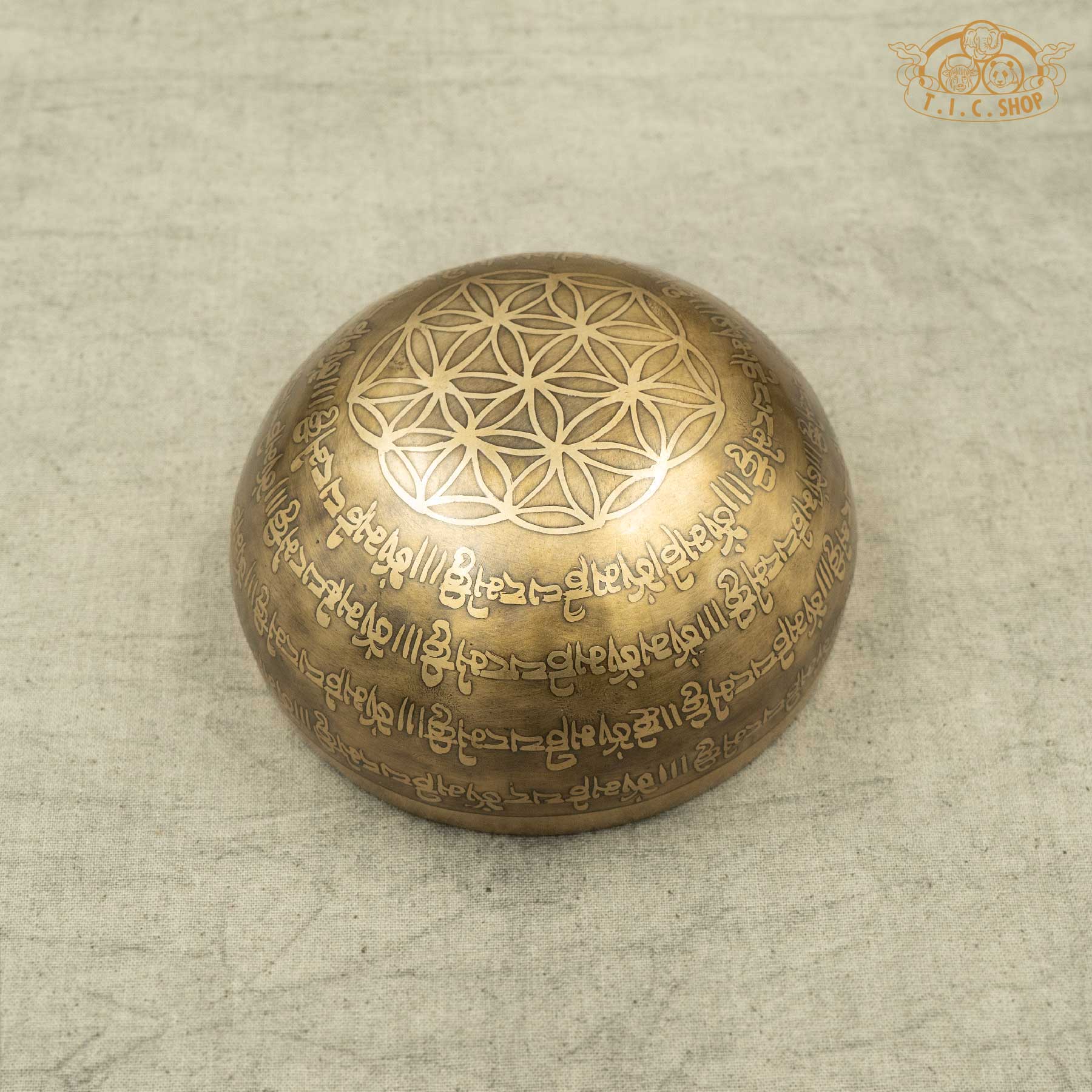 Back view of Om Tibetan singing bowl displaying handcrafted base and unique artisan markings, made in Nepal for meditation use