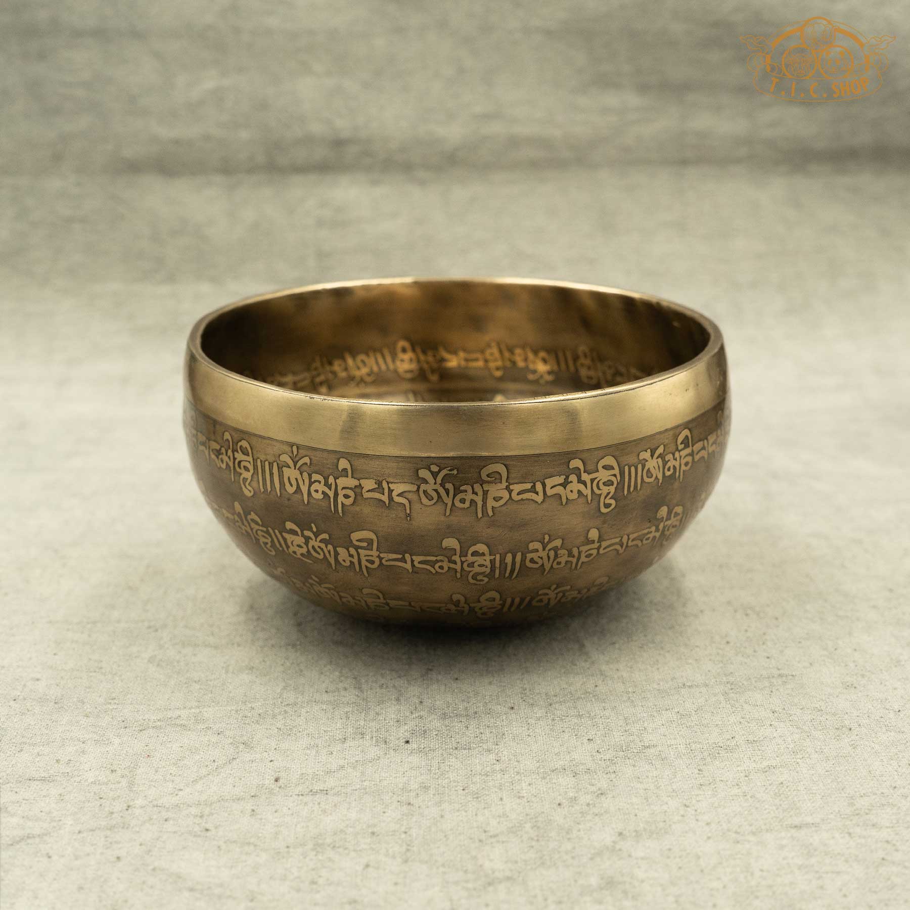 Side view of Om Tibetan singing bowl highlighting the hammered bronze texture and engraved Om symbol, handmade in Nepal