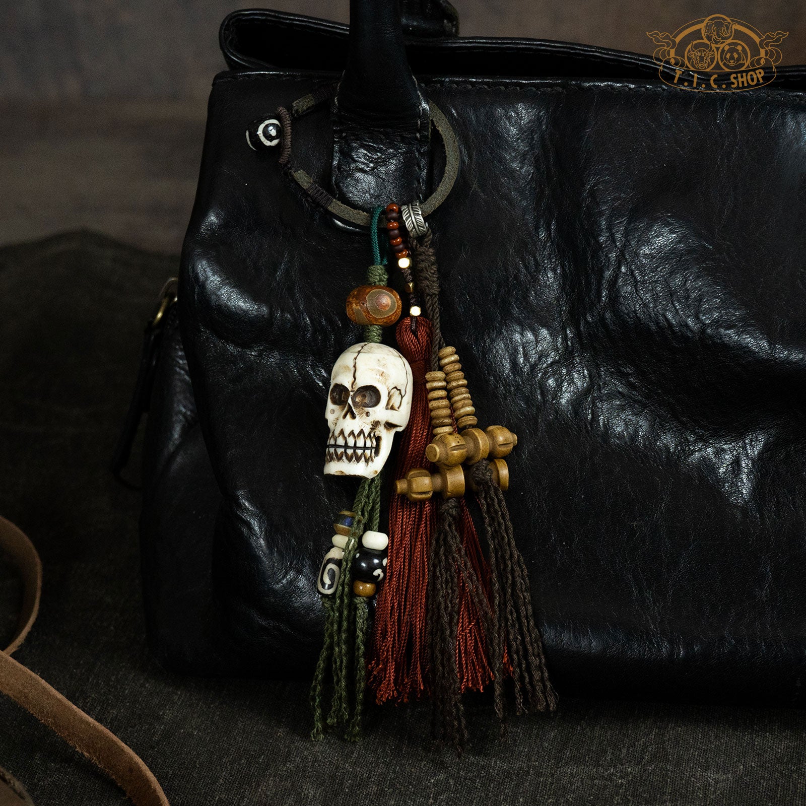 A hand-woven hanging amulet with a skull design, featuring Yak bone and colorful tassels