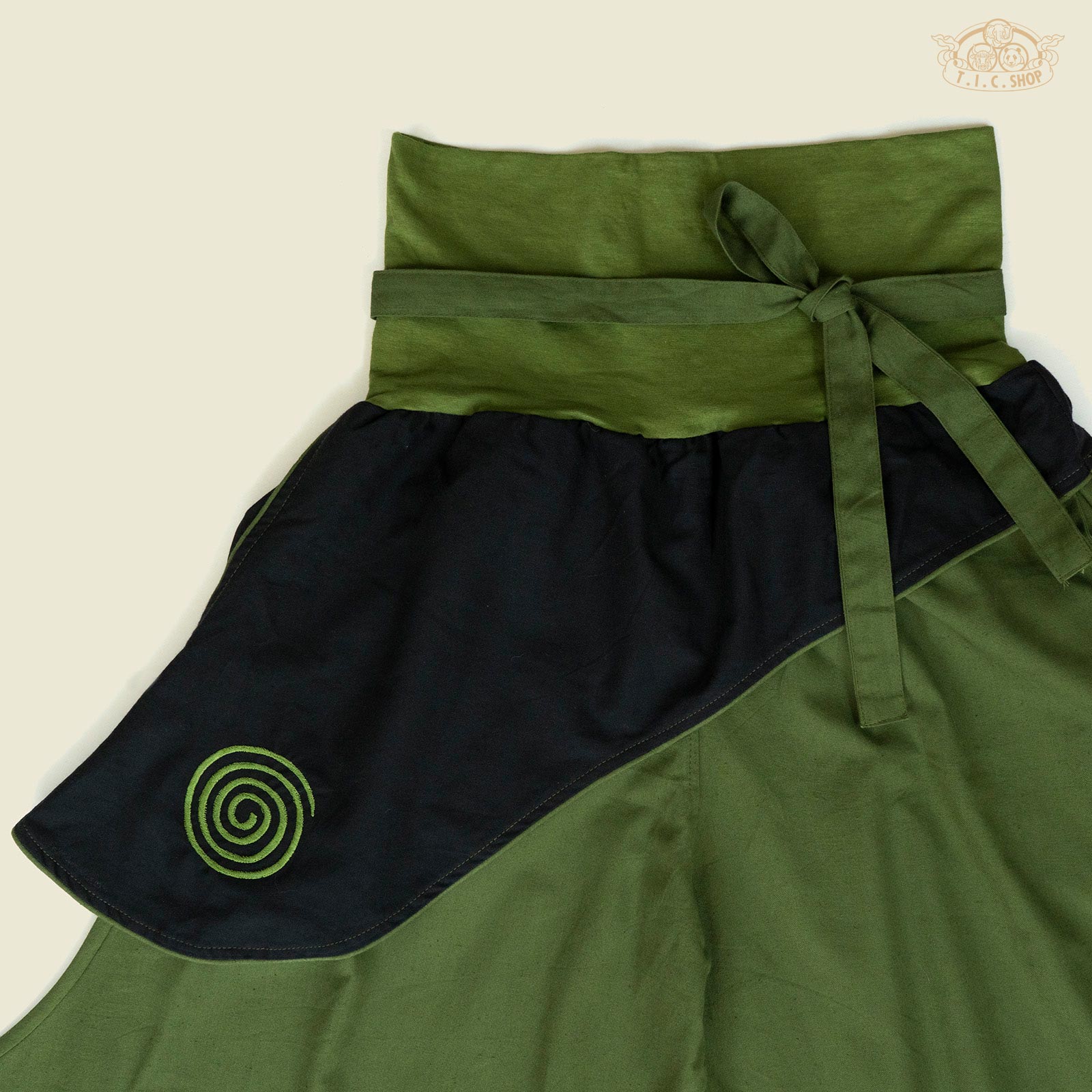 Side view highlighting side-seam pockets and elastic waistband.