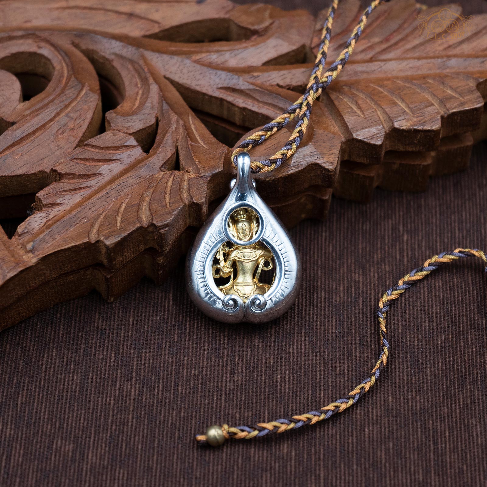 Back view of Manjushri amulet pendant, showing sculpted details and depth