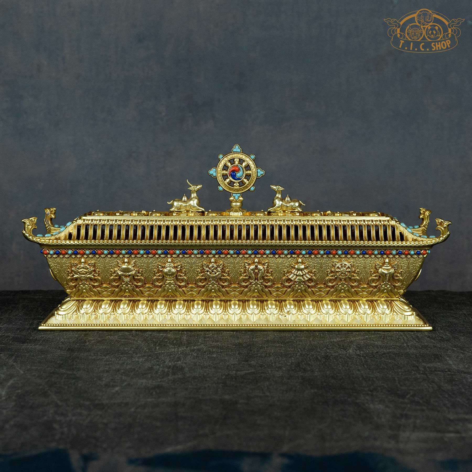 Back view of brass incense burner featuring Eight Auspicious Objects and detailed relief design.