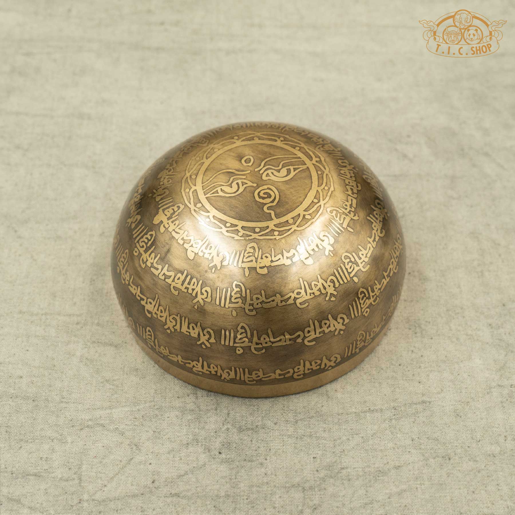 Back view of Handmade Tibetan singing bowl from Nepal with carved OM MANI PADME HUN mantra and Mandala pattern for meditation and healing