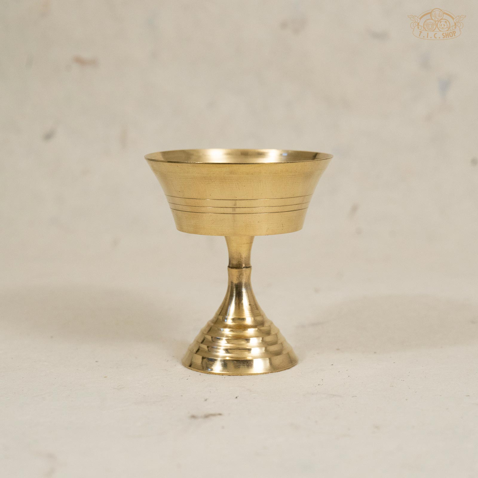 Front view of small brass butter lamp with simple traditional design and smooth finish.